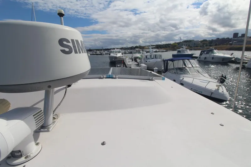 Karma Sea's Yacht Photos Pics 2001 Grady-White Express 330 boat docked in a marina with other vessels.