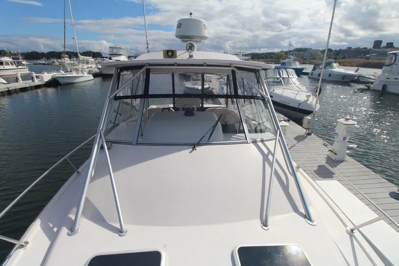 Karma Sea's Yacht Photos Pics 2001 Grady-White Express 330 boat docked at marina under cloudy sky.