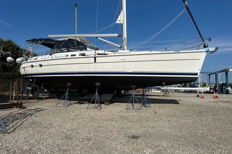 Free Range Yacht Photos Pics 2005 Hunter 44 sailboat on stands in a boatyard under clear blue sky.