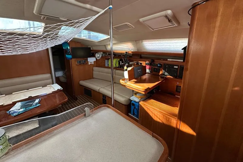 Free Range Yacht Photos Pics Interior of 2005 Hunter 44 sailboat with wood finish and navigation station.