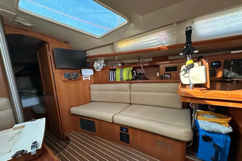 Free Range Yacht Photos Pics Interior of 2005 Hunter 44 sailboat with beige seating and wooden accents.