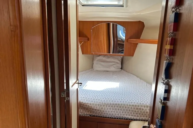 Free Range Yacht Photos Pics Cozy cabin interior of 2005 Hunter 44 sailboat with wooden finish and comfortable bedding.