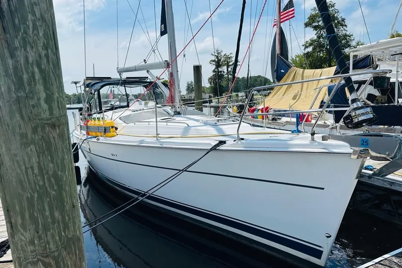 Free Range Yacht Photos Pics 2005 Hunter 44 sailboat docked at marina with American flag.