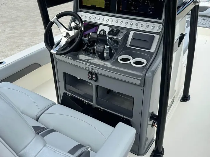  Yacht Photos Pics 2021 ShearWater 270 Carolina Flare boat console with steering wheel and controls.