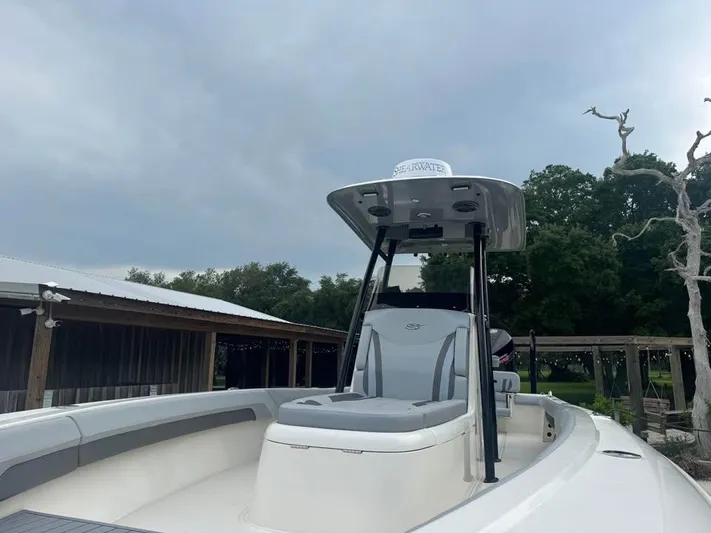  Yacht Photos Pics 2021 ShearWater 270 Carolina Flare boat, sleek design, overcast sky background.