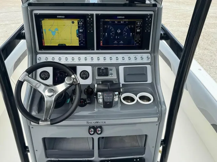  Yacht Photos Pics 2021 ShearWater 270 Carolina Flare boat dashboard with dual Simrad displays and steering wheel.