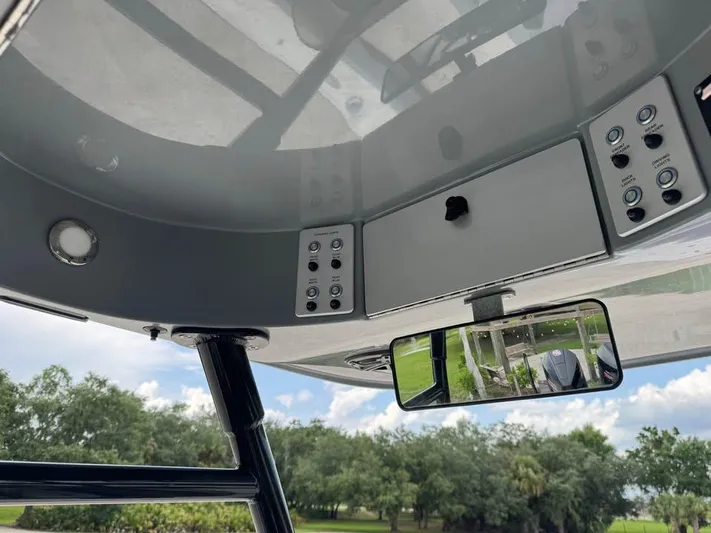  Yacht Photos Pics 2021 ShearWater 270 Carolina Flare boat console with controls and rearview mirror.