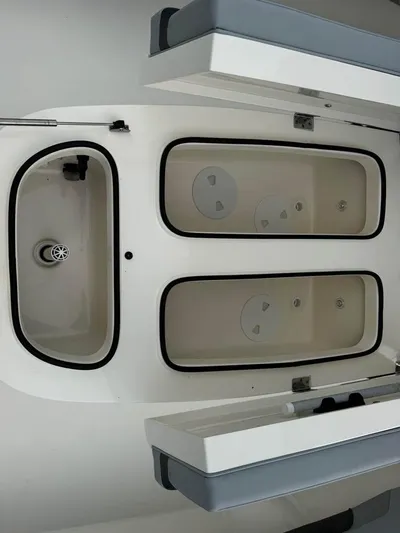  Yacht Photos Pics 2021 ShearWater 270 Carolina Flare boat interior with storage compartments.