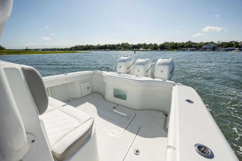  Yacht Photos Pics 2022 Yellowfin 34 boat with triple engines on a sunny day.