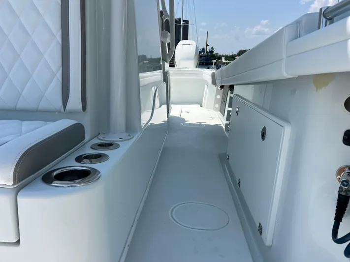  Yacht Photos Pics 2022 Yellowfin 34 boat interior with white seating and storage compartments.