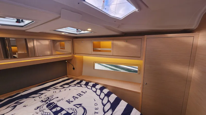 New Stock Boat - Available Now Yacht Photos Pics Luxurious cabin interior of 2023 Dufour 470 yacht with modern wood finish.