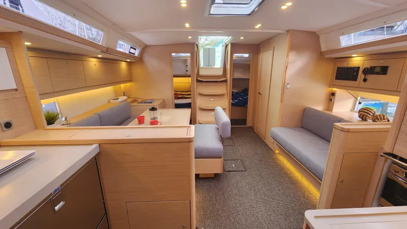 New Stock Boat - Available Now Yacht Photos Pics Modern interior of 2023 Dufour 470 yacht, featuring sleek design and comfortable seating.