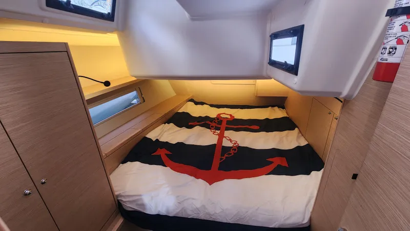 New Stock Boat - Available Now Yacht Photos Pics 2023 Dufour 470 cabin with anchor-themed bedding and modern wood finish.