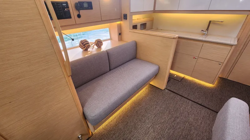 New Stock Boat - Available Now Yacht Photos Pics Modern interior of 2023 Dufour 470 yacht with cozy seating and elegant lighting.