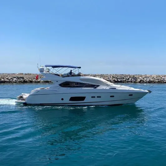 Nm01655 Yacht Photos Pics 2011 Sunseeker Manhattan 63 yacht cruising on calm blue waters.