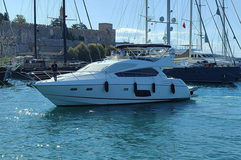 Nm01655 Yacht Photos Pics 2011 Sunseeker Manhattan 63 yacht docked in a marina with sailboats.