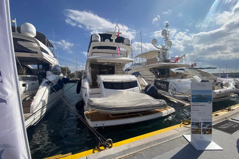 Nm01655 Yacht Photos Pics Luxurious 2011 Sunseeker Manhattan 63 yacht docked at marina under blue sky.