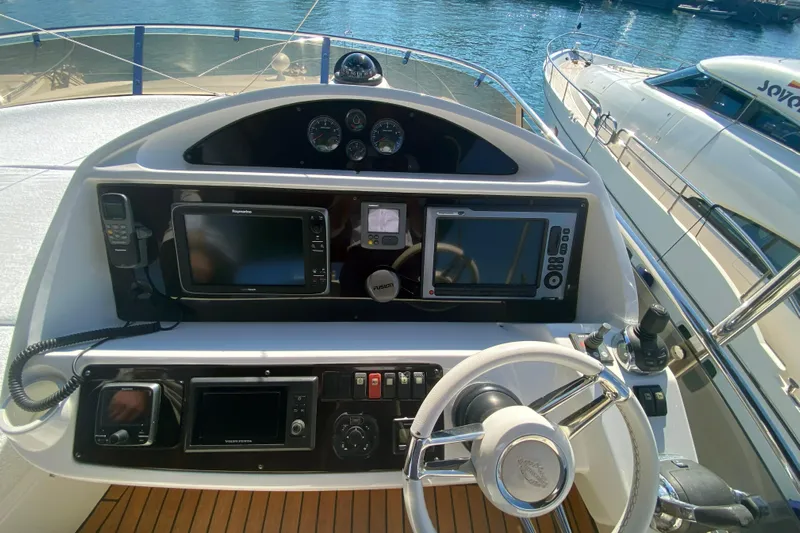 Nm01655 Yacht Photos Pics Helm of 2011 Sunseeker Manhattan 63 yacht with navigation equipment and steering wheel.