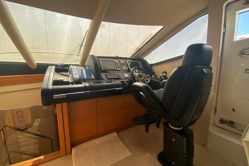Nm01655 Yacht Photos Pics Helm station of 2011 Sunseeker Manhattan 63 yacht with leather captain's chair and control panel.