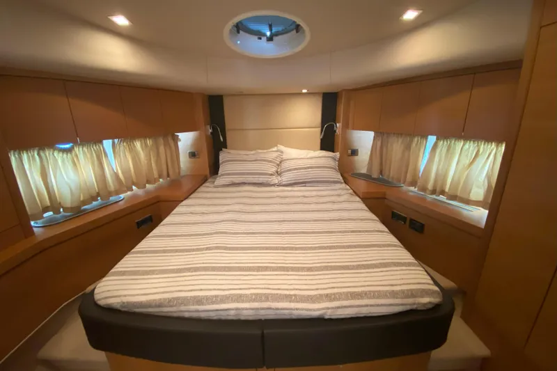 Nm01655 Yacht Photos Pics Luxurious bedroom interior of 2011 Sunseeker Manhattan 63 yacht with cozy bed and ambient lighting.