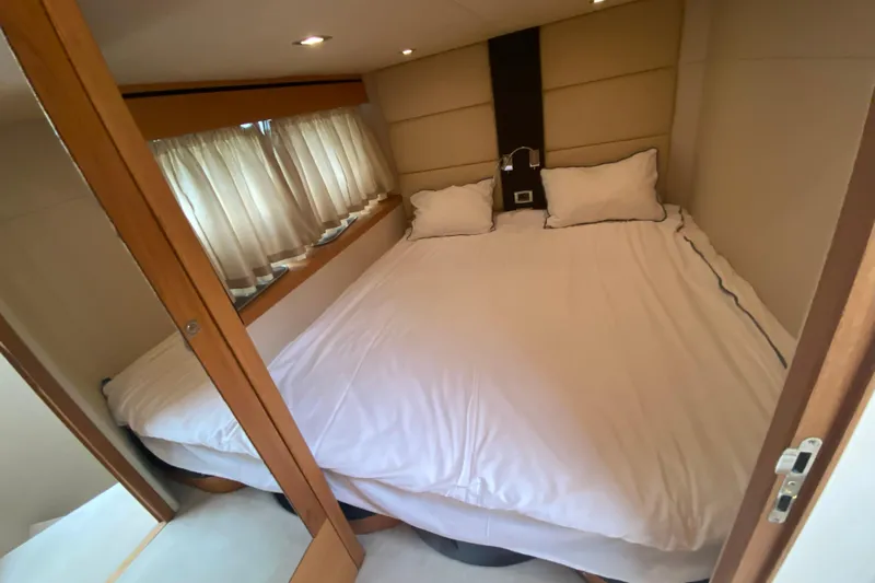 Nm01655 Yacht Photos Pics Luxurious bedroom interior of 2011 Sunseeker Manhattan 63 yacht with cozy bedding.