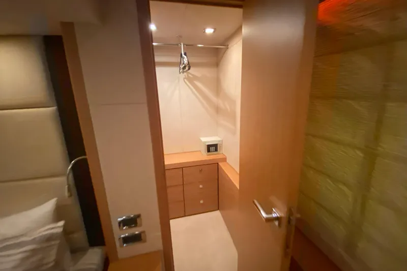 Nm01655 Yacht Photos Pics Interior view of a 2011 Sunseeker Manhattan 63 yacht closet with safe and wooden cabinetry.