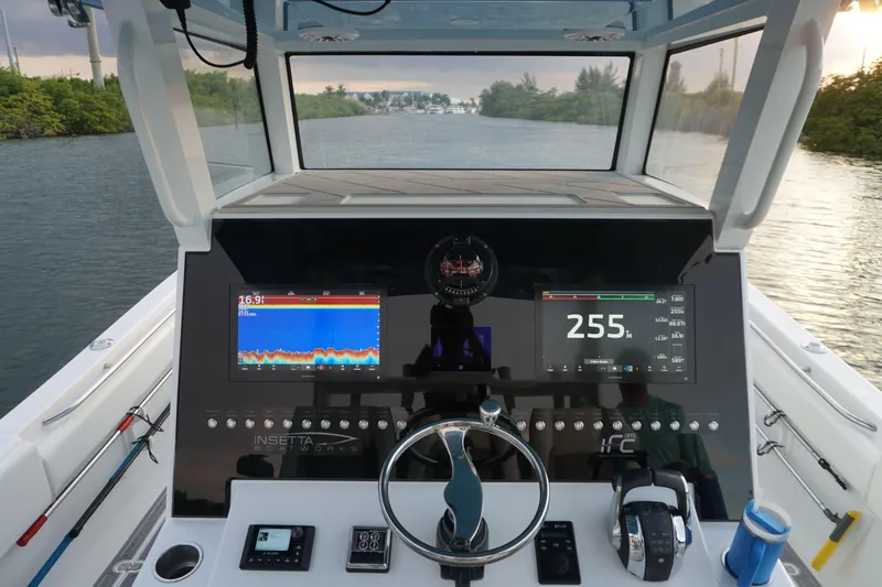  Yacht Photos Pics 2022 Insetta 35IFC boat dashboard with navigation screens and steering wheel.