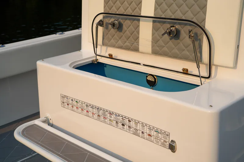  Yacht Photos Pics 2022 Insetta 35IFC boat interior with open storage compartment and quilted upholstery.