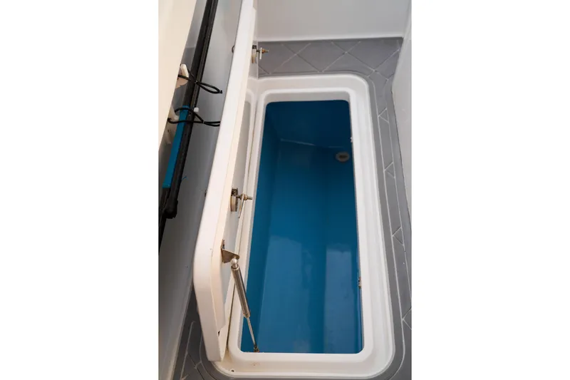  Yacht Photos Pics Open storage compartment on 2022 Insetta 35IFC boat, featuring blue interior and secure latches.