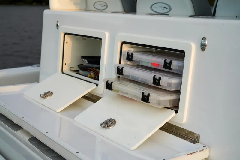  Yacht Photos Pics 2022 Insetta 35IFC boat storage compartments with organized tackle boxes.
