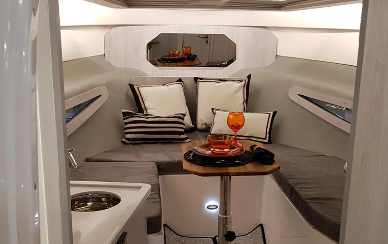Custom Order Yours Today! Yacht Photos Pics 2025 Hanover 355 Outboard cabin interior with cozy seating and elegant decor.