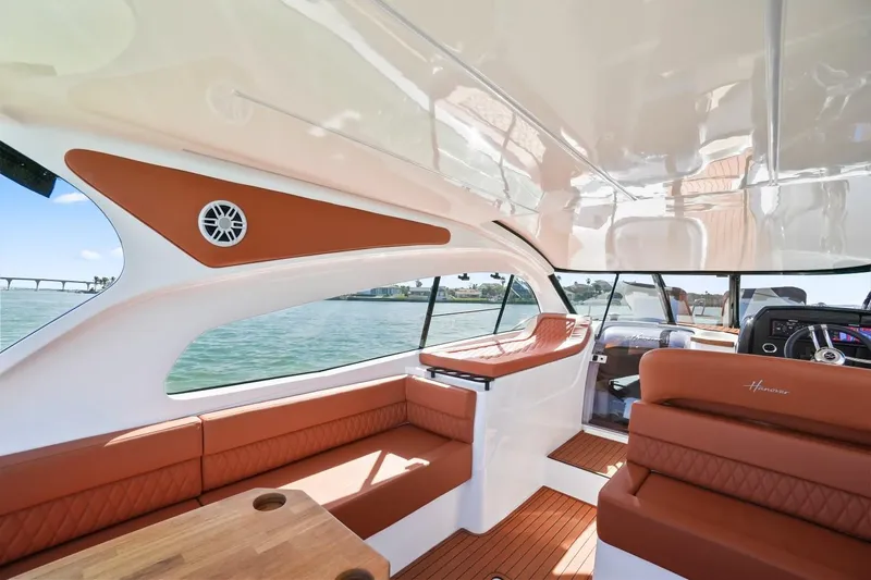 Custom Order Yours Today! Yacht Photos Pics Luxurious interior of 2025 Hanover 355 Outboard boat with leather seating and wood accents.