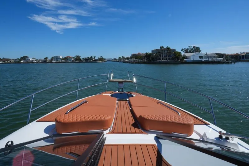 Custom Order Yours Today! Yacht Photos Pics 2025 Hanover 355 Outboard boat cruising on a sunny day, with waterfront view.