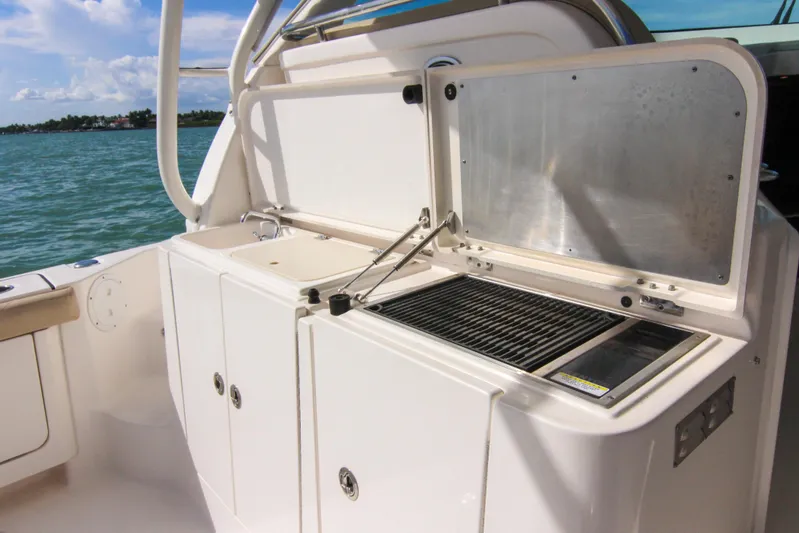  Yacht Photos Pics 2016 Pursuit OS 385 Offshore boat with outdoor kitchen and grill by the sea.