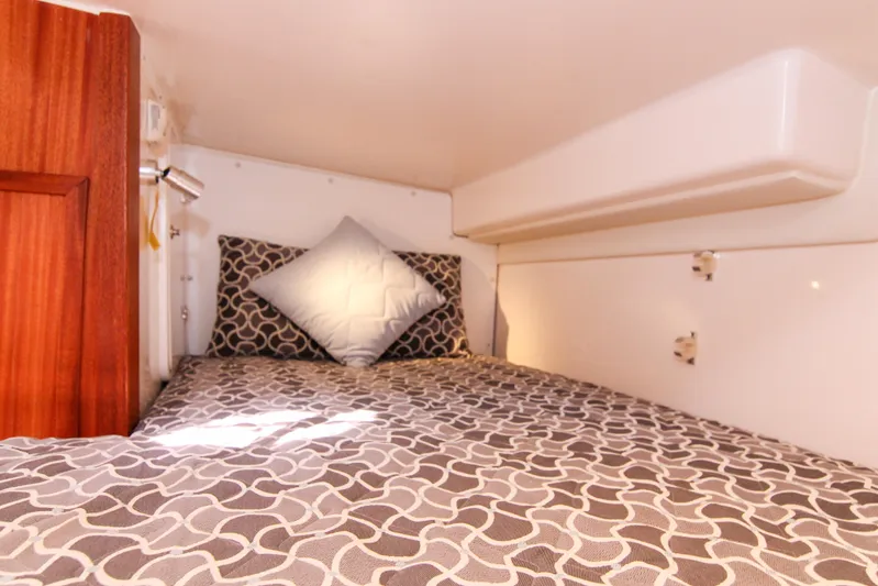  Yacht Photos Pics Cozy cabin bed in 2016 Pursuit OS 385 Offshore boat with patterned bedding.