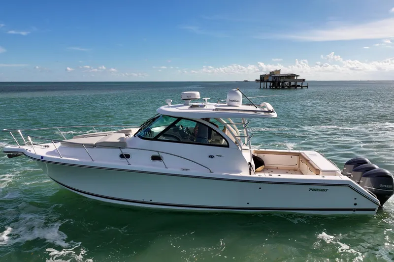  Yacht Photos Pics 2016 Pursuit OS 385 Offshore boat cruising on clear ocean waters.