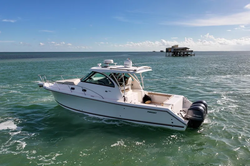  Yacht Photos Pics 2016 Pursuit OS 385 Offshore boat cruising on open water under clear skies.