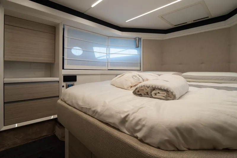 Curly Yacht Photos Pics Luxurious bedroom interior of 2021 Cranchi E52S yacht with modern design and cozy bedding.