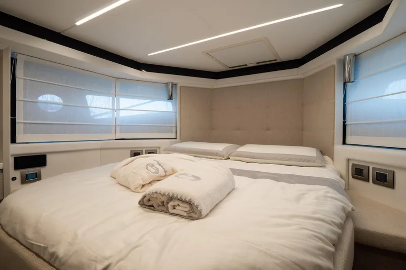 Curly Yacht Photos Pics Luxurious bedroom interior of 2021 Cranchi E52S yacht with modern design and cozy bedding.