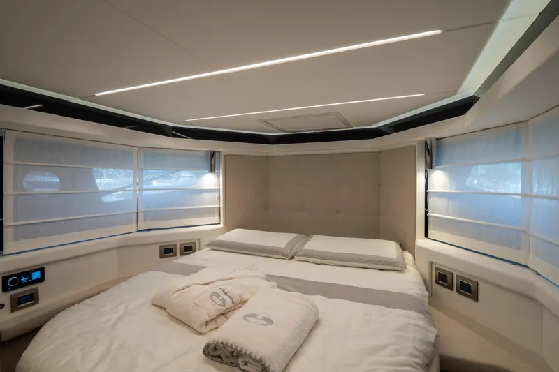 Curly Yacht Photos Pics Luxurious bedroom interior of 2021 Cranchi E52S yacht with modern design and ambient lighting.