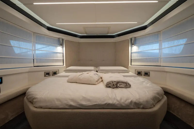 Curly Yacht Photos Pics Luxurious bedroom interior of 2021 Cranchi E52S yacht with modern design and ambient lighting.