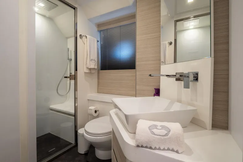 Curly Yacht Photos Pics Modern bathroom in 2021 Cranchi E52S yacht with sleek fixtures and elegant design.