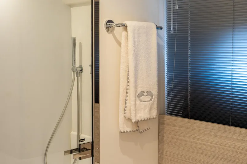 Curly Yacht Photos Pics Modern bathroom in 2021 Cranchi E52S yacht with shower and towel rack.