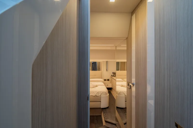 Curly Yacht Photos Pics Luxurious interior of 2021 Cranchi E52S yacht, featuring a cozy bedroom.