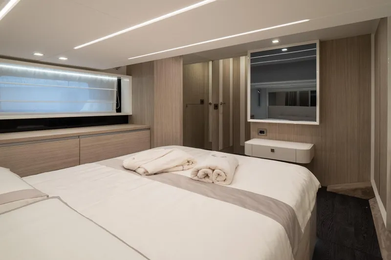 Curly Yacht Photos Pics Luxurious 2021 Cranchi E52S yacht bedroom with modern design and elegant furnishings.