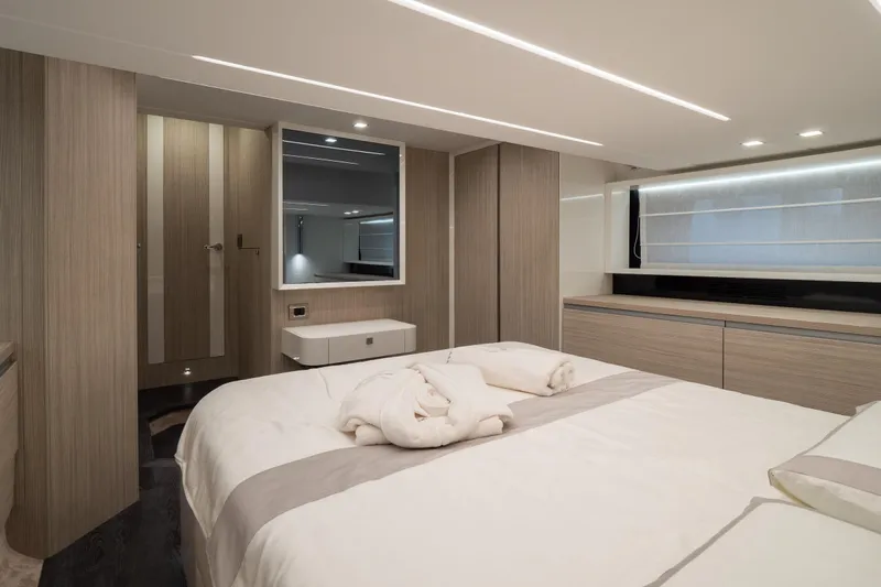 Curly Yacht Photos Pics Luxurious interior of 2021 Cranchi E52S yacht bedroom with modern design and elegant furnishings.