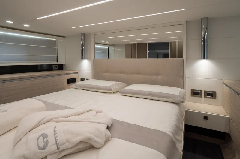 Curly Yacht Photos Pics Luxurious bedroom interior of 2021 Cranchi E52S yacht with modern design and ambient lighting.