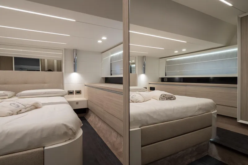 Curly Yacht Photos Pics Luxurious bedroom interior of 2021 Cranchi E52S yacht, featuring modern design and ambient lighting.