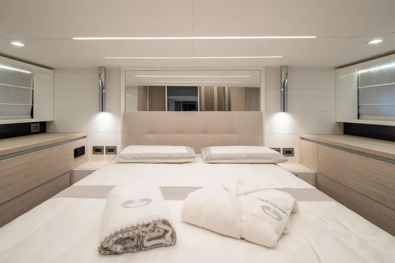 Curly Yacht Photos Pics Luxurious bedroom interior of 2021 Cranchi E52S yacht, featuring modern design and elegant lighting.