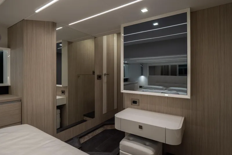 Curly Yacht Photos Pics Luxurious interior of 2021 Cranchi E52S yacht with modern wood paneling and sleek mirror.